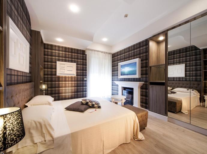 Camera da letto moderna con decorazioni a quadri e specchi.