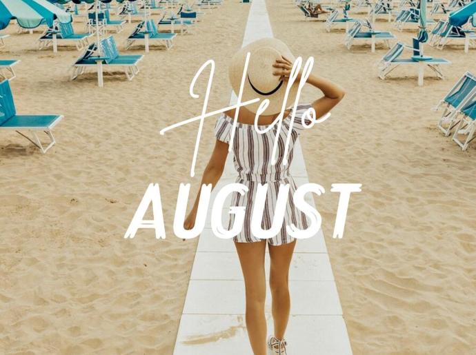 Woman on beach with blue umbrellas, welcoming August.