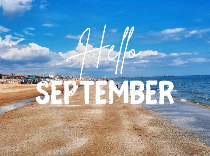 Peaceful beach with 'Hello September' text.