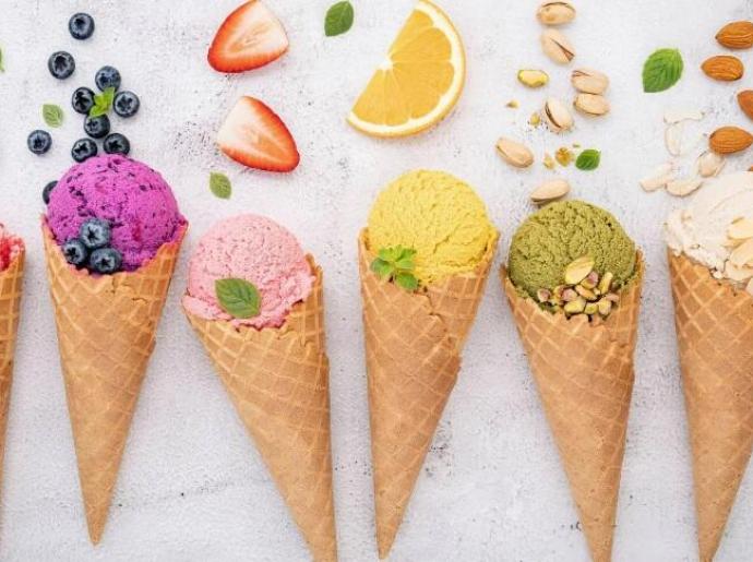 Colorful ice cream cones with fruits and nuts.
